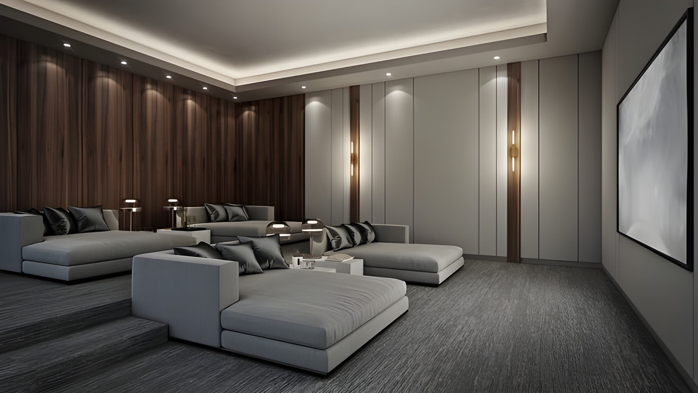 A theater with wood wall panels and tiered grey chaise seating
